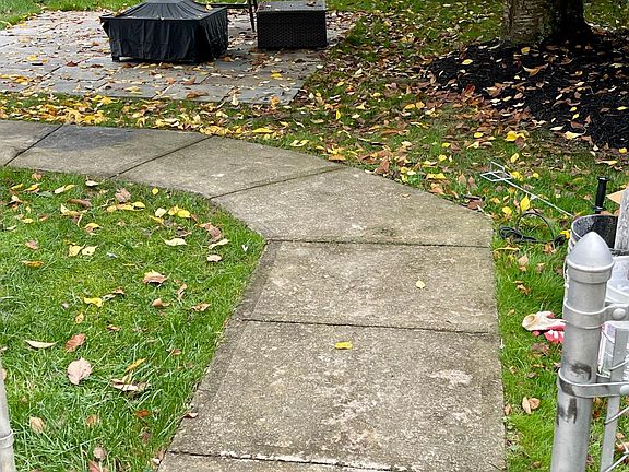 Paved sidewalk around back of house