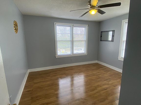 Large master bedroom hardwood flooring, and ceiling fan