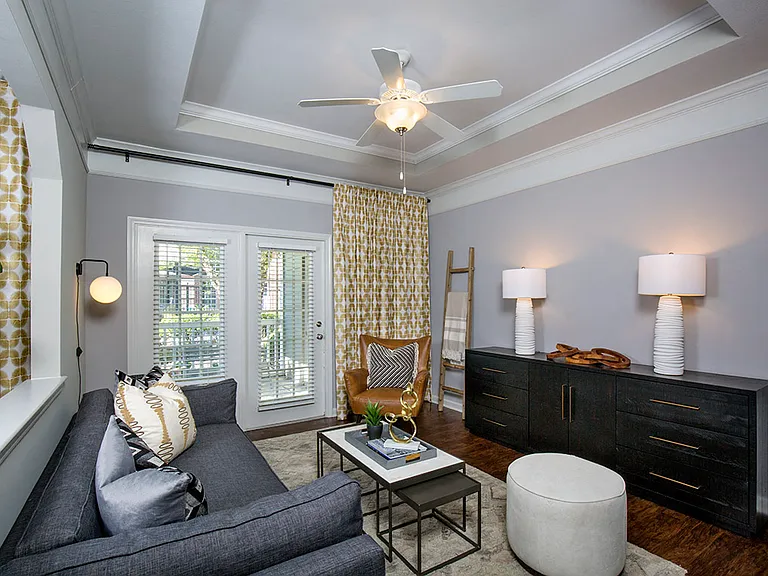 Living room with crown molding and tray ceiling