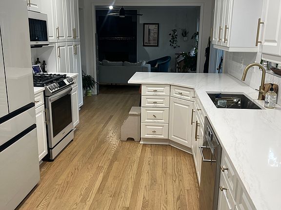 Kitchen looking into gas fireplace den.