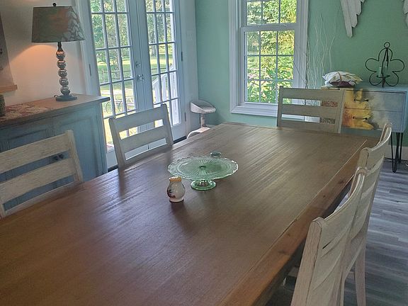 Dining area faces backyard with french doors to patio.