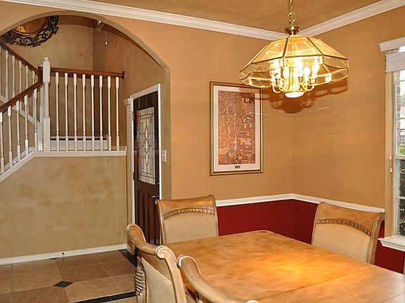Grand portion formal dining room on the other side of the entry hall with ceramic title floors
