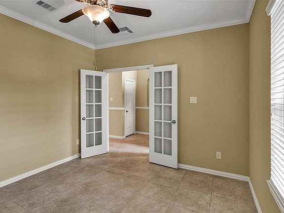 View from inside Study/Office.  Crown Molding, Ceiling fan and custom blinds on window to bring the outside in while you work!