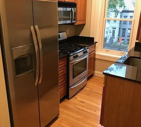 Kitchen, including new refridgerator, dishwasher, stove, microwave oven, sink, maple cabinets, and granite