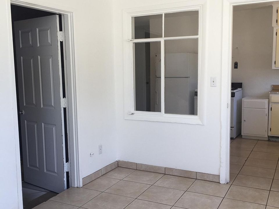 From outside patio into house , 
To the left is large laundr