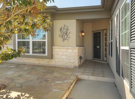 A lovely Magnolia tree graces the stone Courtyard, the perfect welcoming committee for this delightful home!