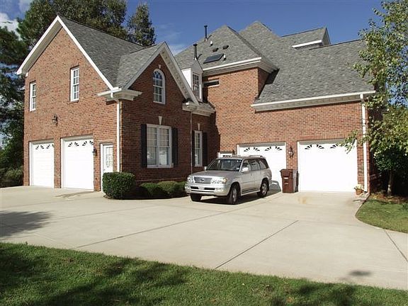 4 Car Garage; Driveway with beautiful stamped concrete accents.