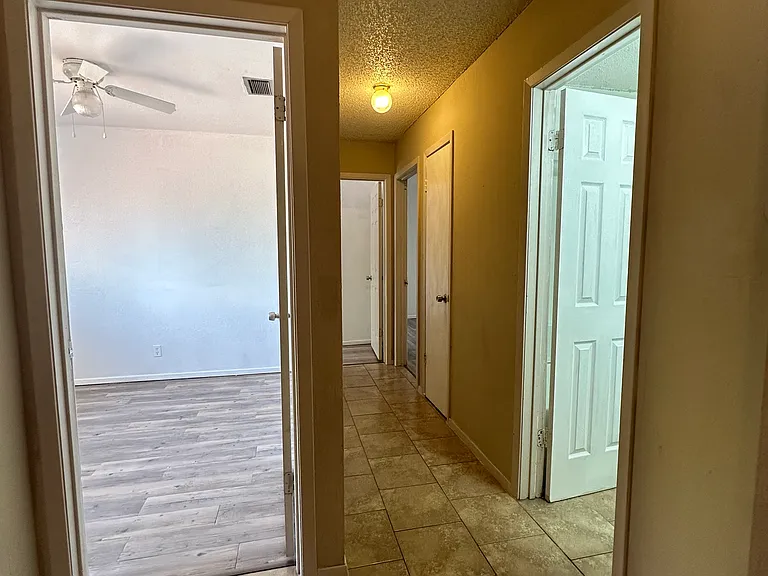 Upstairs hallway leading to bedrooms and restroom