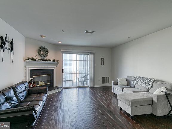 Living room w/ fireplace & slider to balcony