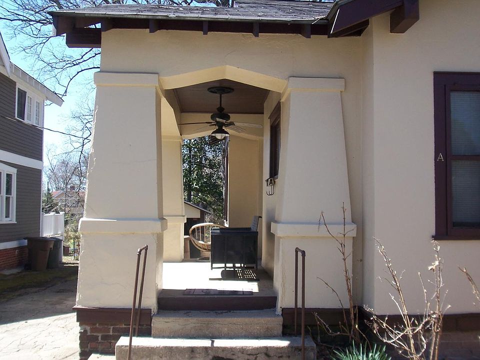Entance to unit w/ covered sitting porch, glidder & fan