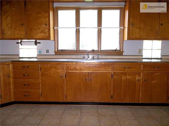 Kitchen features lots of custom cabinets with lazy-sussanne.