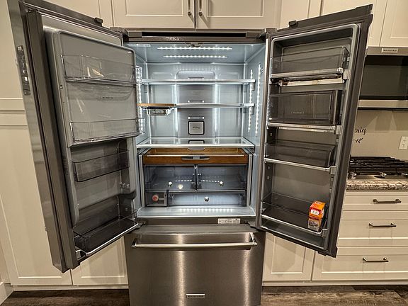 High-end KitchenAid stainless steel French door refrigerator with plenty of storage space and sleek design. A perfect blend of style and functionality for your kitchen!