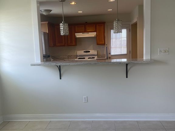 ENTER INTO FRONT DOOR TO DEN, NEW GRANITE KITCHEN BAR OPENING TO THE KITCHEN