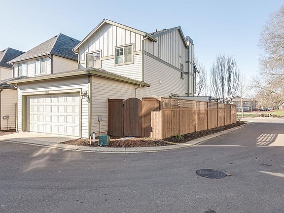 Back of home with attached 2 car garage