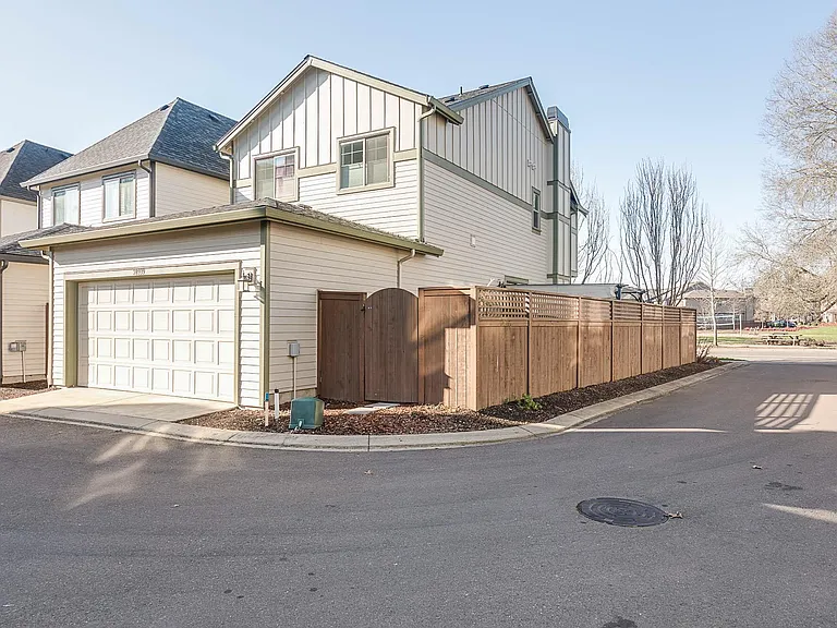 Back of home with attached 2 car garage