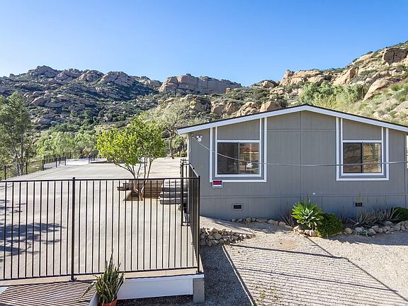 Side view of the house with the deck overlooking 180 views of the mountains and valley
