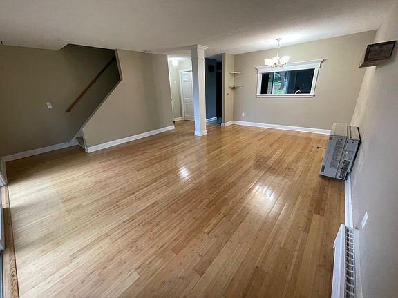 Living and dining space with pass through window to kitchen. Beautiful bamboo floors!