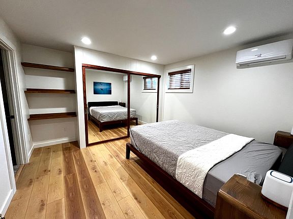 Sliding mirrored closet with ample storage space. Comfy queen size bed.