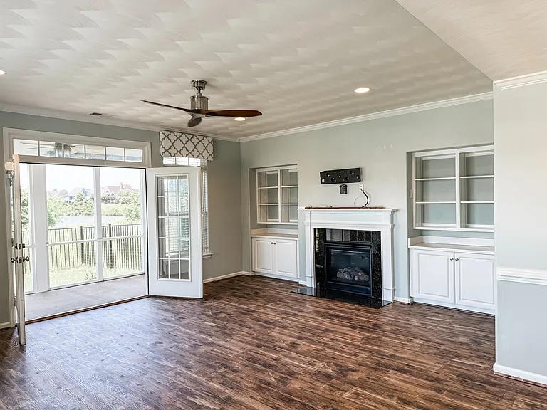 Living room with French doors and gas fireplace.