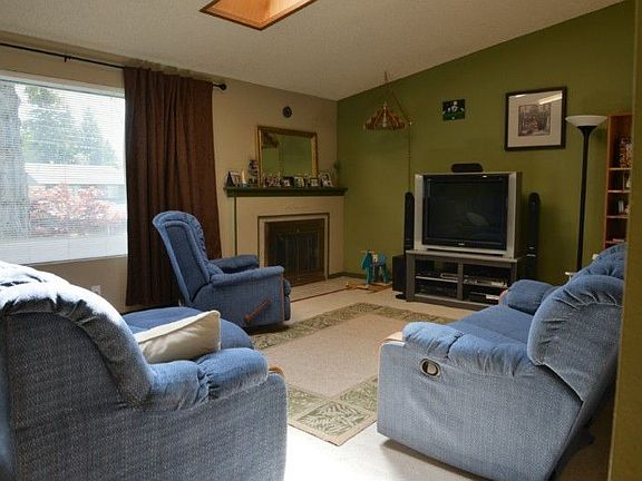 Light and Bright Livingroom with a Fireplace, Skylights, and Vaulted Ceiling