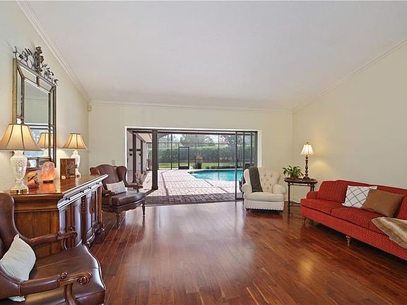 Formal Living Room with triple pocket sliders to Lanai and Pool