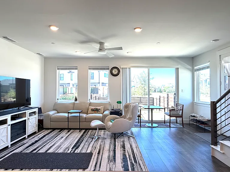 The bright and spacious living room offers neighborhood views.