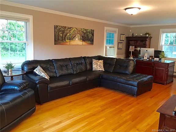 Remodeled living room with oak hardwood floors, new windows, crown molding