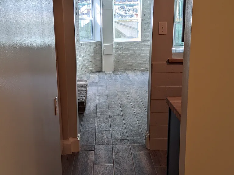 View from hallway to bedroom. Large storage closet (not in view) directly to left, bathroom directly to right.