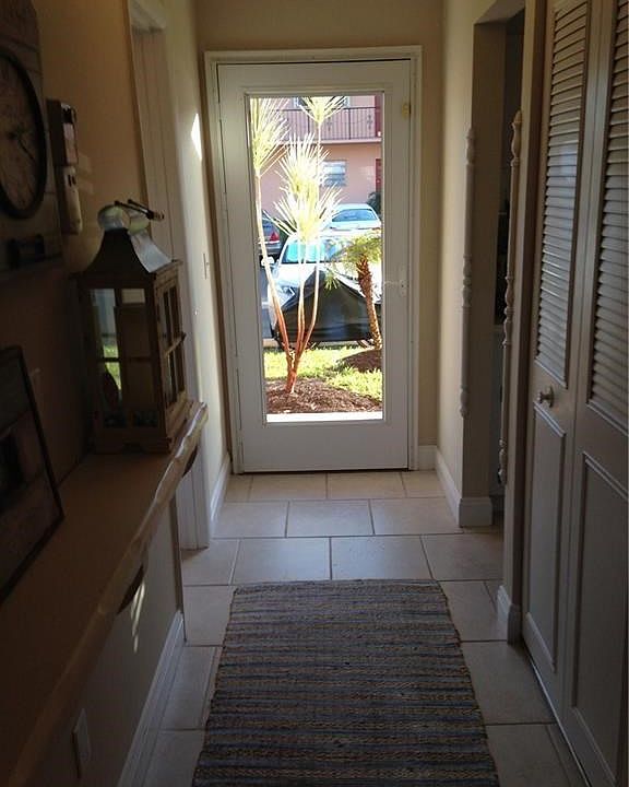 Tiled entry foyer with glass entry door
