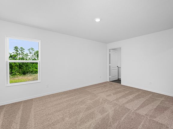 The master bedroom is spacious and has access to its own bathroom