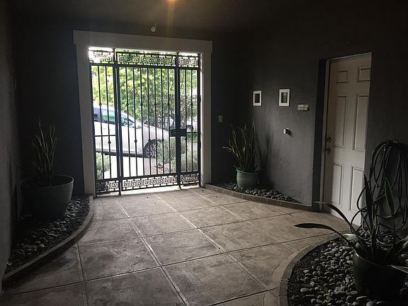 Gate to entryway courtyard and door access to garage