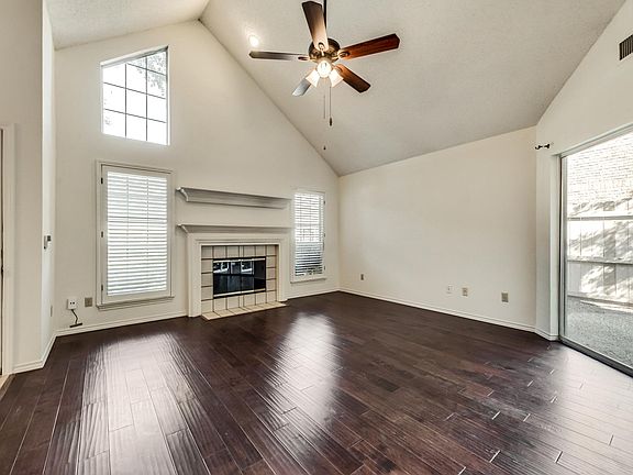 Wood floored living room with fireplace