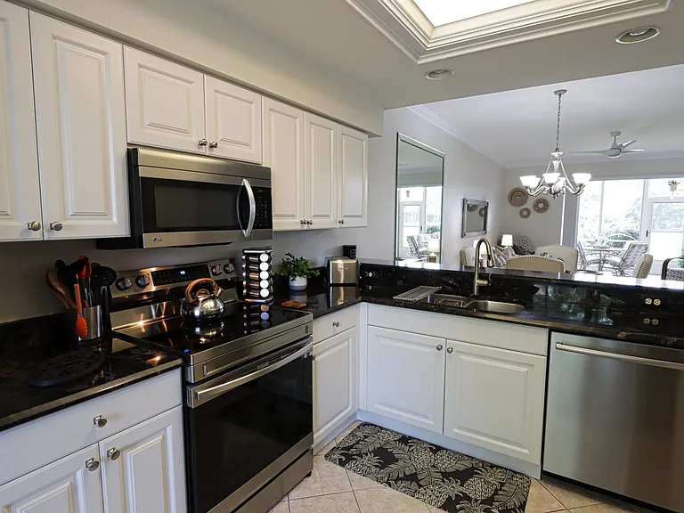 Fully equipped kitchen w/plenty of storage, granite countertops, and new stove and dishwasher