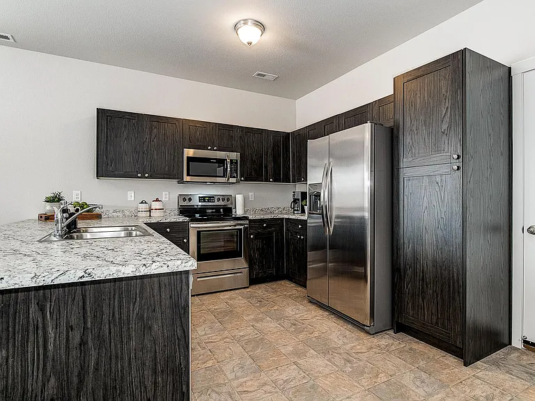Kitchen with stainless steel appliances and large cabinets