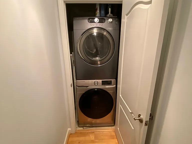 In-unit stacked washer/dryer tucked away yet easy to access.