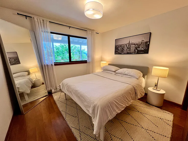 One of two lower-level bedrooms with a queen bed and long closet along with peek-a-boo views of the lake.