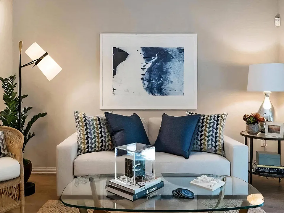 Layered lamps and pale walls keep the room warm after the sun drops.