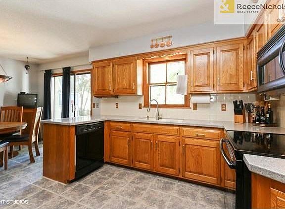 Eat In Kitchen with Corian Counter Tops and Sink and Tile Floors.