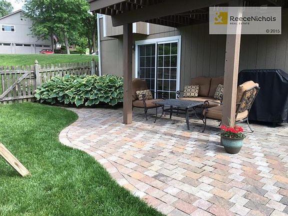 Walkout basement to a brick patio and beautiful Hosta plants!