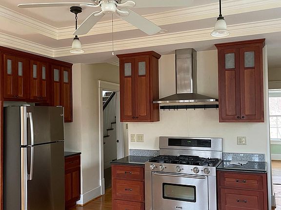 kitchen with stainless steel appliances, granite countertops, and custom cherry cabinets