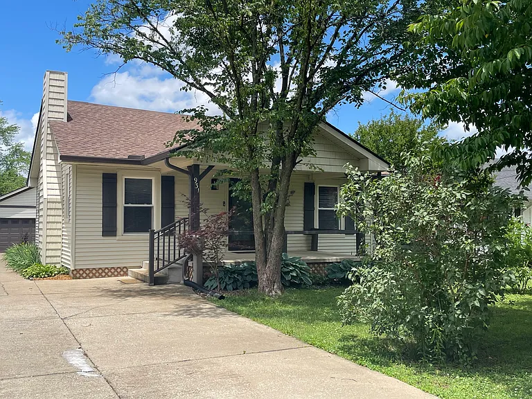 Cozy home in desirable neighborhood with large, inviting porch and shady front yard.