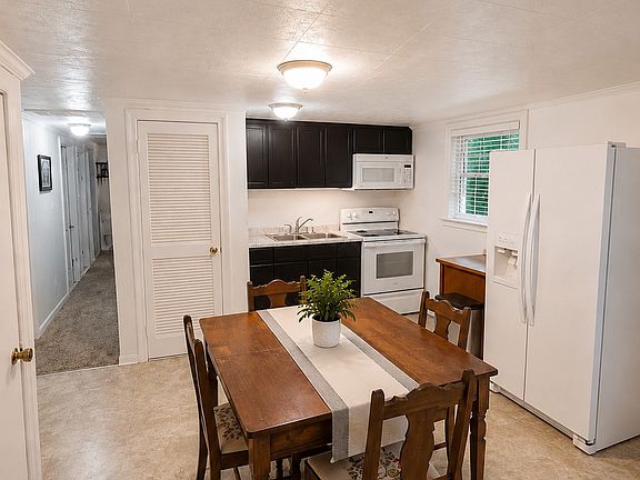 Additional view of kitchen and hallway leading from living room