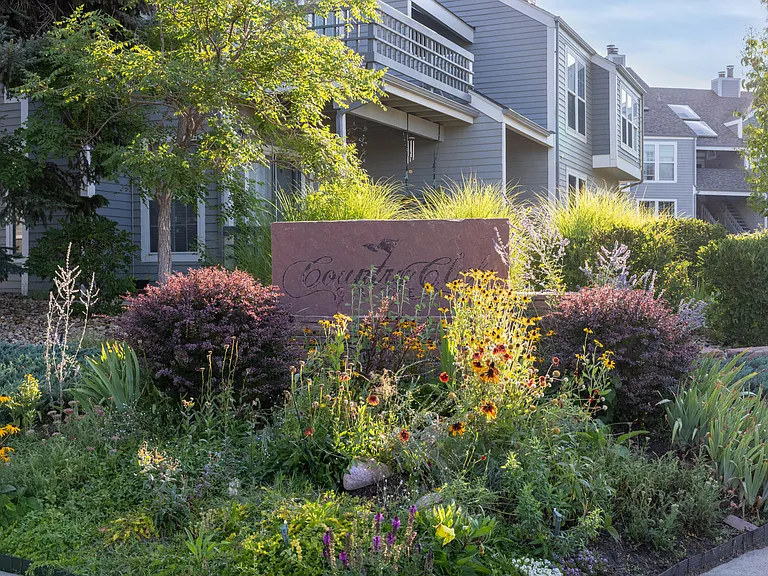 Lush landscaping and colorful seasonal gardens contribute to the neighborhood's inviting atmosphere.
