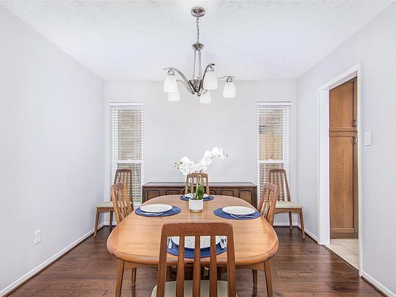 Lovely formal dining with wood flooring and windows for light.
