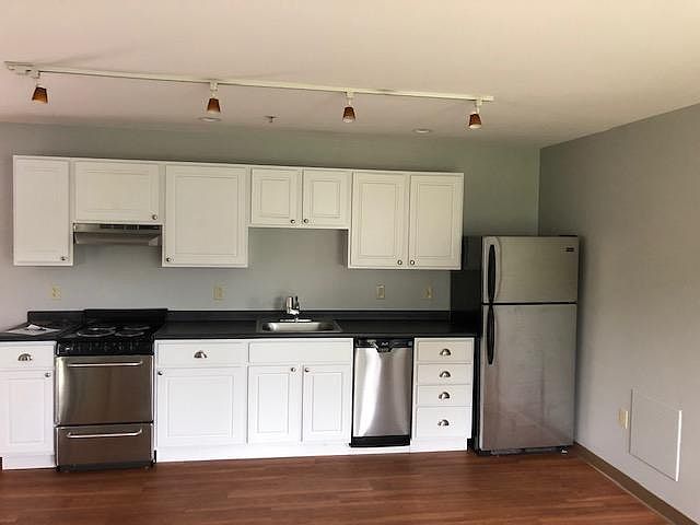 Kitchen area including stove, dishwasher and refridgerator. Heat (included in rent) is radiant.