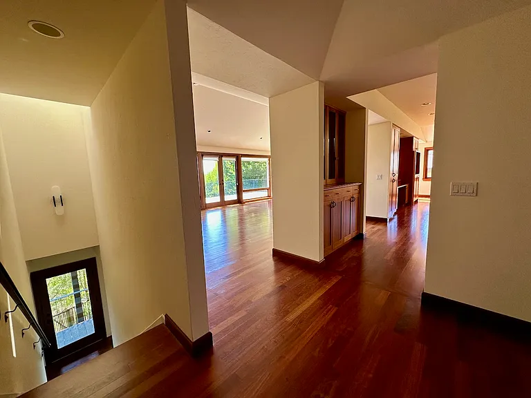 Central area once you enter from front door. Stairs ahead, living from and kitchen to the right. Hallway to the left leads to bedrooms, bathroom, storage and laundry.