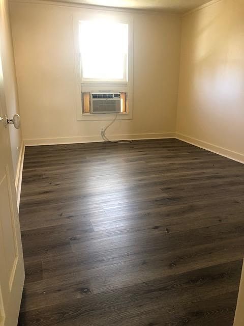 Bedroom with window air conditioner.