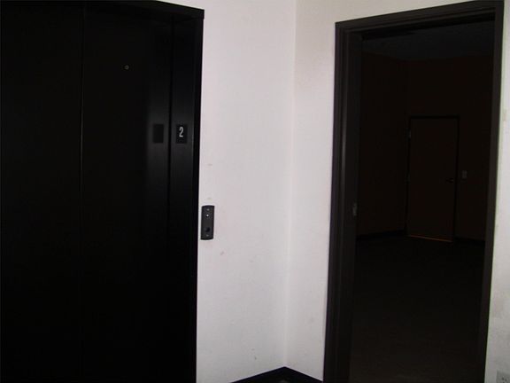 Door to space next to elevator door