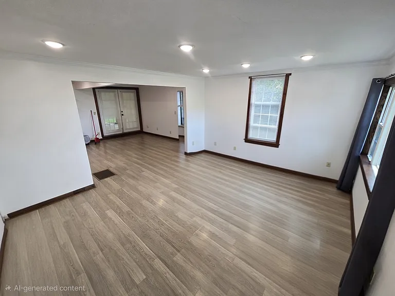View of living room from front door. (Photo editing used to remove furniture in order to give a better understanding of the space.)