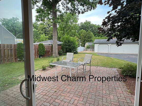 patio/backyard view with detached 3 car garage